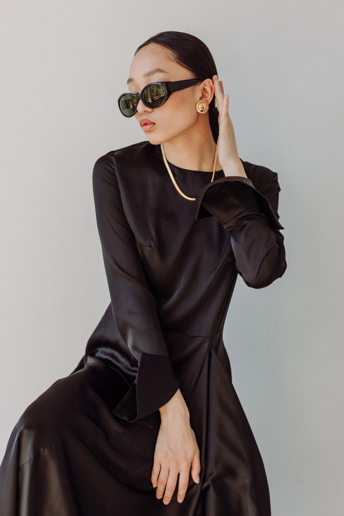 Fashion editorial featuring a sculptural black tailored suit, from the Design Days brochure